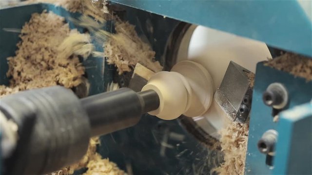 Figured cutting on a tree, the machine cuts a figure from a tree, the CNC machine, furniture factory, the machine cuts a detail from a wood, the machine cuts a carving on a tree