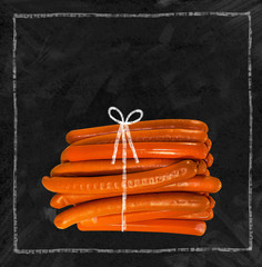 A lot of sausages on a black chalkboard. Place for text. For sausage lovers.