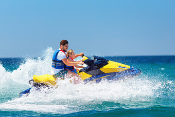 happy, excited family, father and son having fun on jet ski at summer vacation - Powered by Adobe
