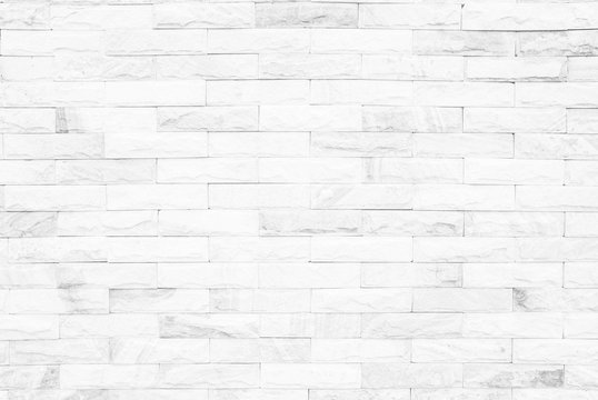 White brick wall texture background or stonework flooring interior rock old pattern clean concrete grid uneven bricks design stack. grey colors brick wall art concrete stone texture in wallpaper 