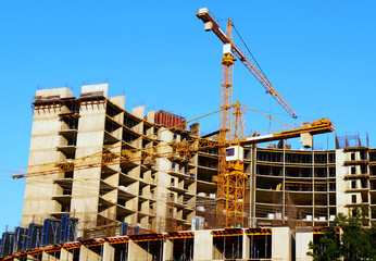 Construction site. Two tower cranes near building. Construction building.