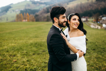 Elegant wedding couple near the mountains at autumn