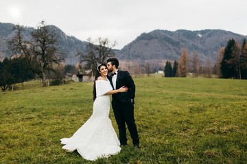 Elegant wedding couple near the mountains at autumn