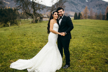 Elegant wedding couple near the mountains at autumn
