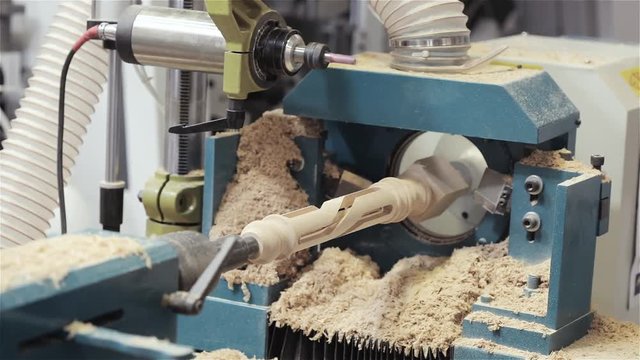 Figured cutting on a tree, the machine cuts a figure from a tree, the CNC machine, furniture factory, the machine cuts a detail from a wood, the machine cuts a carving on a tree