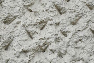 Abstract light decorative plaster wall facade closeup view as textured background.