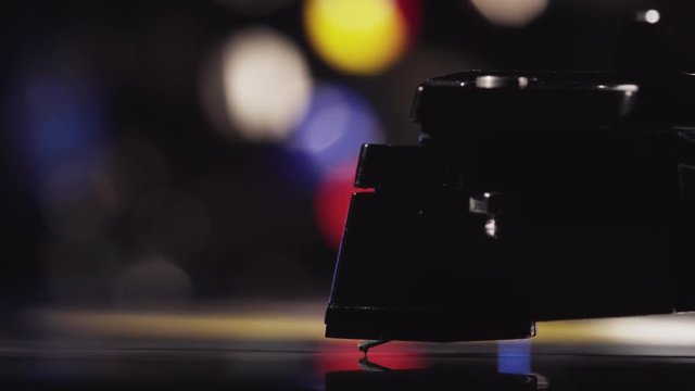 Macro Shot Of A Turntable Cartridge And Stylus Playing A Vinyl Record. Tonarm Is Automatically Removed And The Spinning Record Stops.