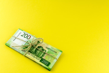 A bundle of money. Russian cash. A bundle tied with a rope. Denominations in 200 rubles.