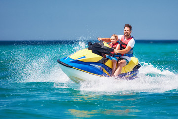 happy, excited family, father and son having fun on jet ski at summer vacation - 212075286