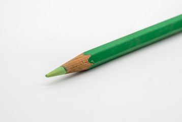 Light green color pencil isolated on white. Selective focus
