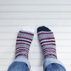 Pair of feet wearing striped socks