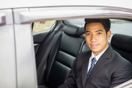 Successful Businessman Sitting In The Back Seat Of A Car