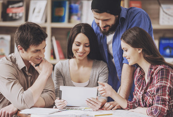 Four Designers Working with Blueprints in Office.