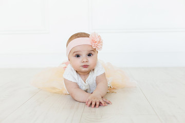 Cute baby on white background.Close up head shot of a caucasian baby girl, six months old baby looking at camera