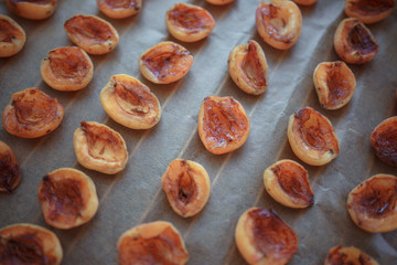 half apricot on baking paper on the grate