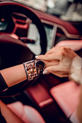 Trendy black watch on woman hand