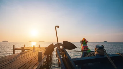 Poster Wooden fishing boat near the pier during sunset. © De Visu