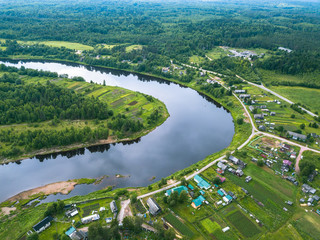 Bird's-eye view of the bend of the river and the village Vazhinka Kurapovo village, Leningrad region, Russia.