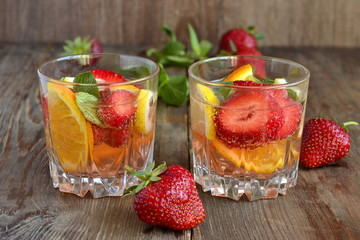 Refreshing summer drink with strawberries and  citrus