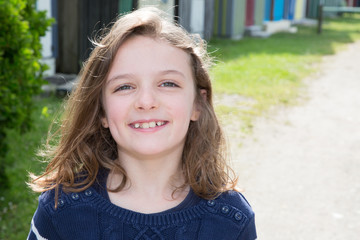 Outdoors portrait of beautiful young brunette child girl