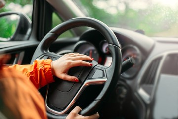  young woman driver driving a business car, on a trip.