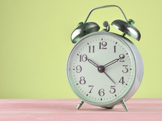 Retro alarm clock on a pastel background, copy space.