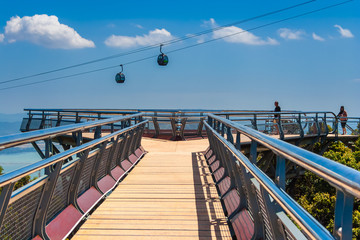 A stroll on the Langkawi Sky Bridge towards the triangular viewing platform at the end from a...
