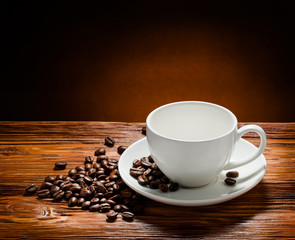 Coffee cup and coffee beans on  wooden background