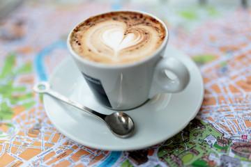 Coffee cup on top of map of Rome