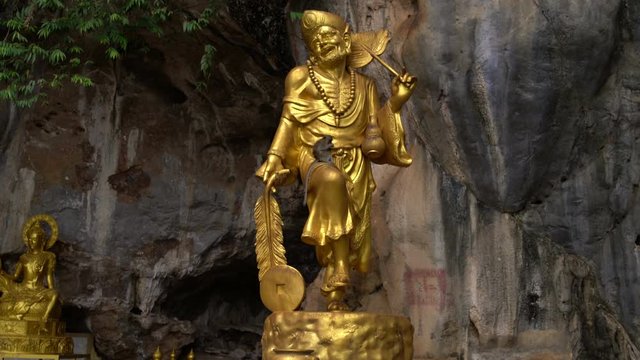 On the golden statue of the deity sits a monkey