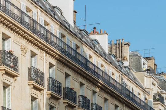Paris residential buildings. Old Paris architecture, beautiful facades, typical french houses on sunny day. Famous travel destinations in Europe. City life, lifestyle and expensive real estate concept