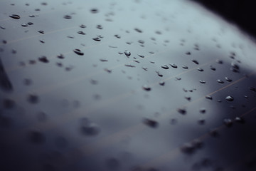 Water on metal. Paint with water. Light light. Droplets of water on the machine.
