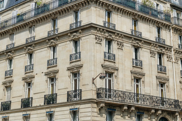 Fototapeta na wymiar Paris residential buildings. Old Paris architecture, beautiful facades, typical french houses. Famous travel destinations in Europe. Backgrounds. City life, lifestyle and expensive real estate concept