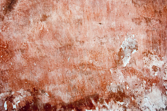 an orange old paint on a solid wall