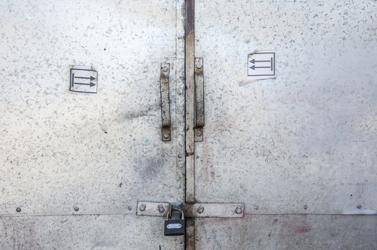 a solid metal doors with padlock