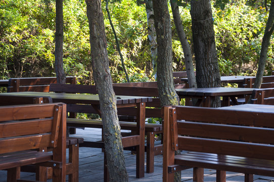 wooden chairs an tables in restaurant garden