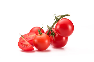 close up view of fresh cherry tomatoes on twig isolated on white