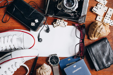 Overhead view of Traveler's accessories, Essential vacation items, Travel concept background. Different objects on wooden background.