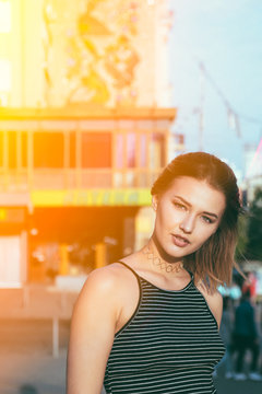 Beautiful and gorgeus blonde girl walking in an urban contest, srong personaliies and self esteem attitude,dreaming pose, natural light, flare.