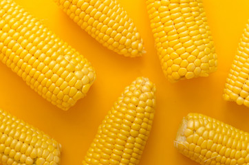 Bright ripe yellow corn on a yellow background in the style of pop art.