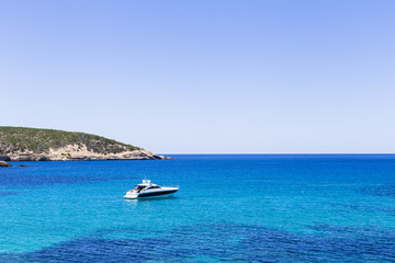 Fototapeta na wymiar beautiful landscape in Ibiza of blue ocean in a sunny day with boats in the horizon. Summer and holidays concept.