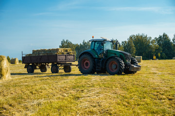 Obraz premium tractor on the field with hay