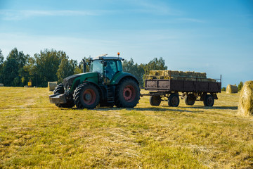 tractor on the field with hay