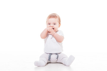 smiling baby sitting on a floor