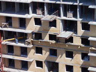 Construction of a multi-apartment residential building. The process of construction. Stages of construction.