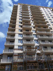 Construction of a multi-apartment residential building. The process of construction. Stages of construction.