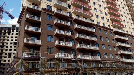 Construction of a multi-apartment residential building. The process of construction. Stages of construction.