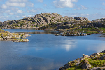 Stony shore of the bay along the western coast of the ocean in the Egersund region, Jaeren national scenic route, Norway