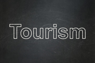 Tourism concept: text Tourism on Black chalkboard background