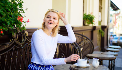Woman elegant happy face have coffee cafe terrace outdoors. Mug of good coffee in morning gives me energy charge. Girl drink coffee every morning at same place as tradition. Great start of day